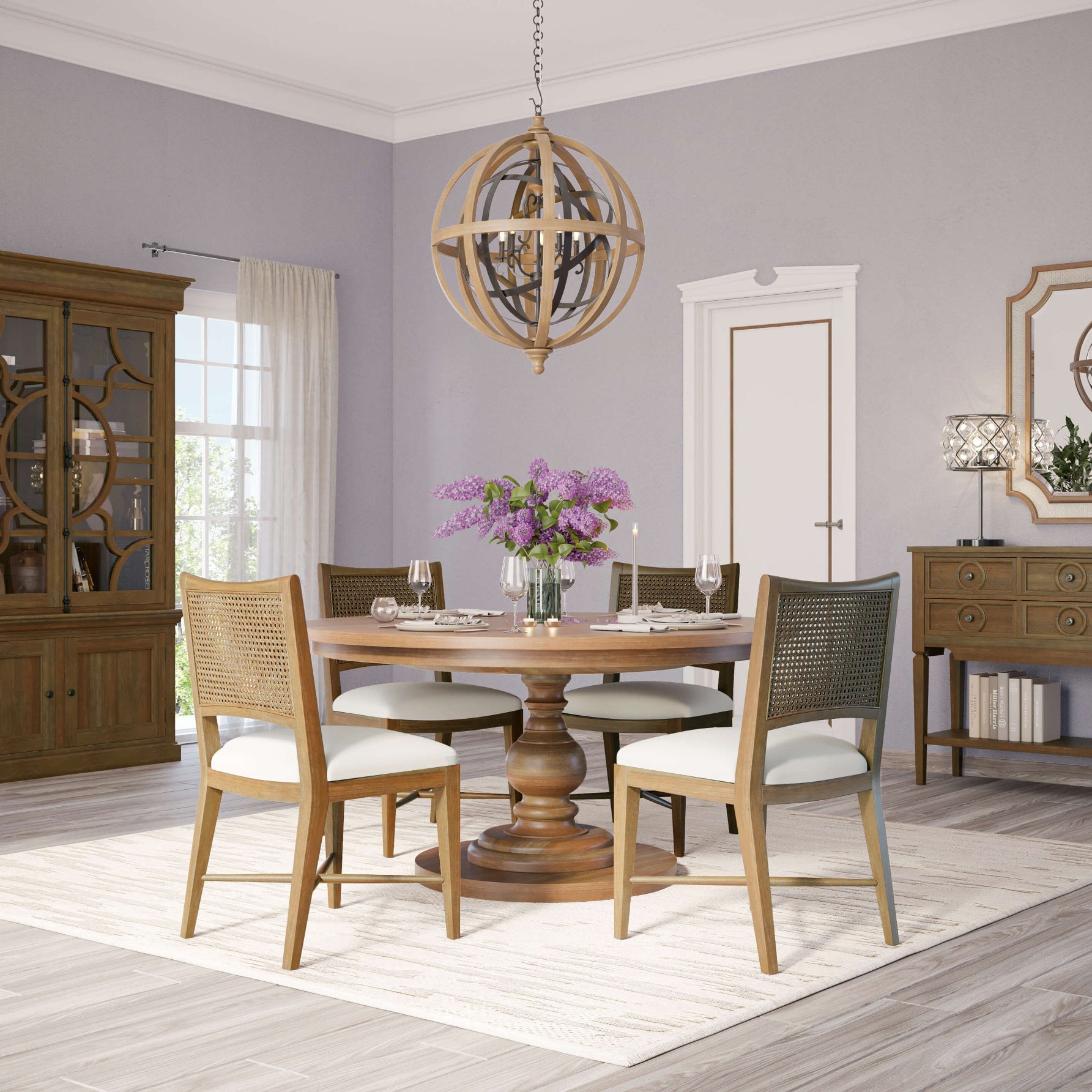 Round dining table in room, chairs around, decorated setting.