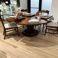 Dining table fully extended with chairs and table settings.