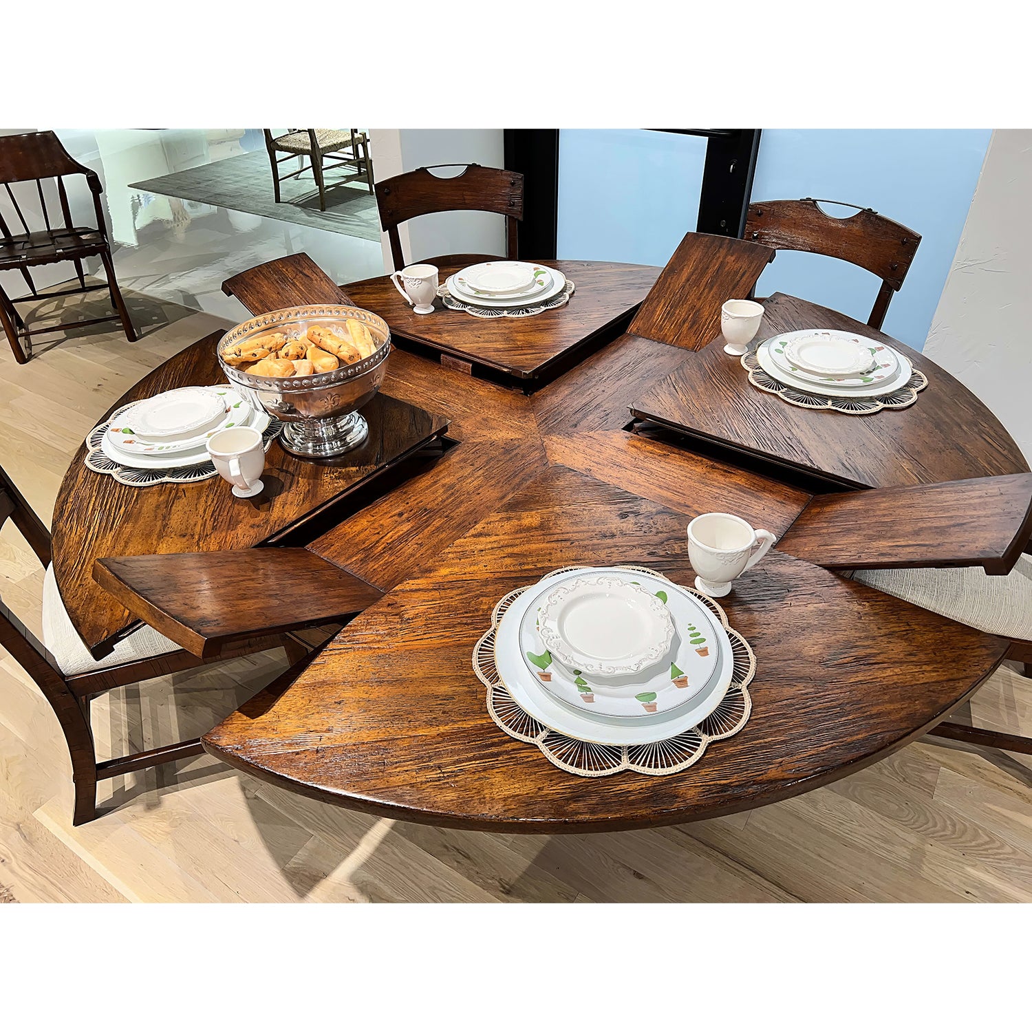 Close-up of table settings on extended round dining table.