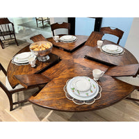 Close-up of table settings on extended round dining table.