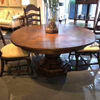 Wooden round dining table in cozy dining room.
