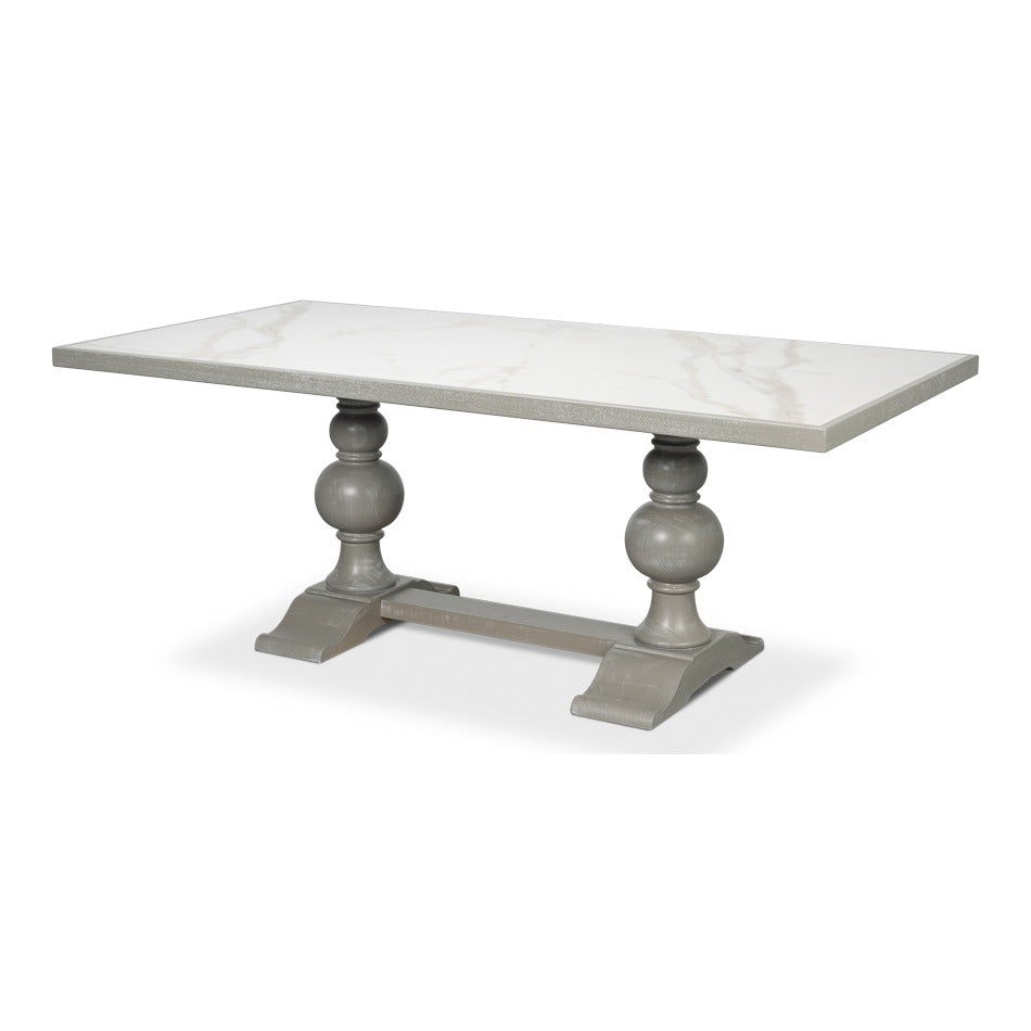 Rectangular dining table with white and grey porcelain Calacatta top on a grey turned trestle base with plinth feet