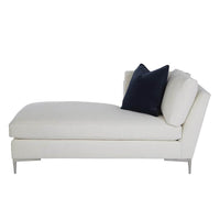 Side view of white chaise and dark pillow.