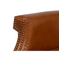 Close-up of armrest detail with nailhead accents.