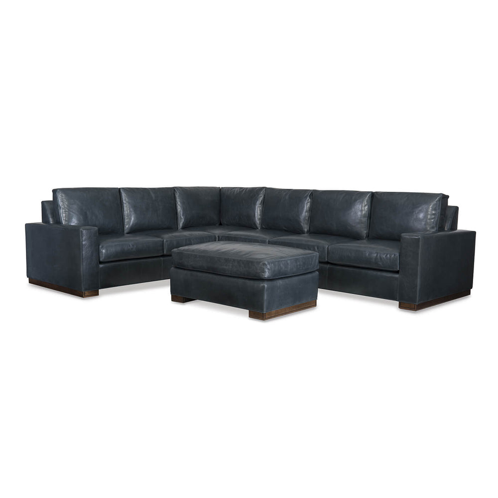 Dark blue leather sectional sofa with ottoman.