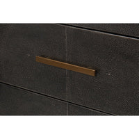 Close-up of sideboard drawer with gold handle.