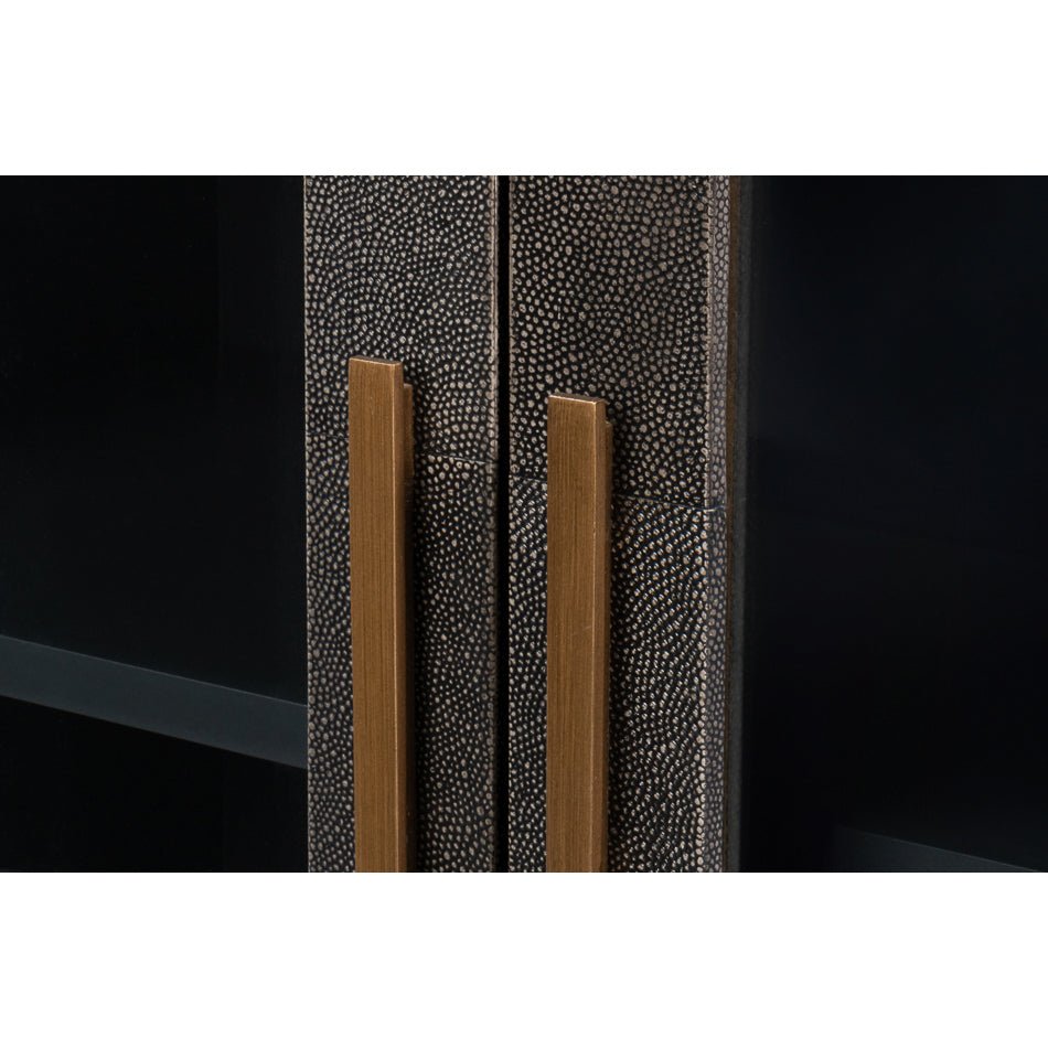 Detail of sideboard cabinet doors with gold handles.