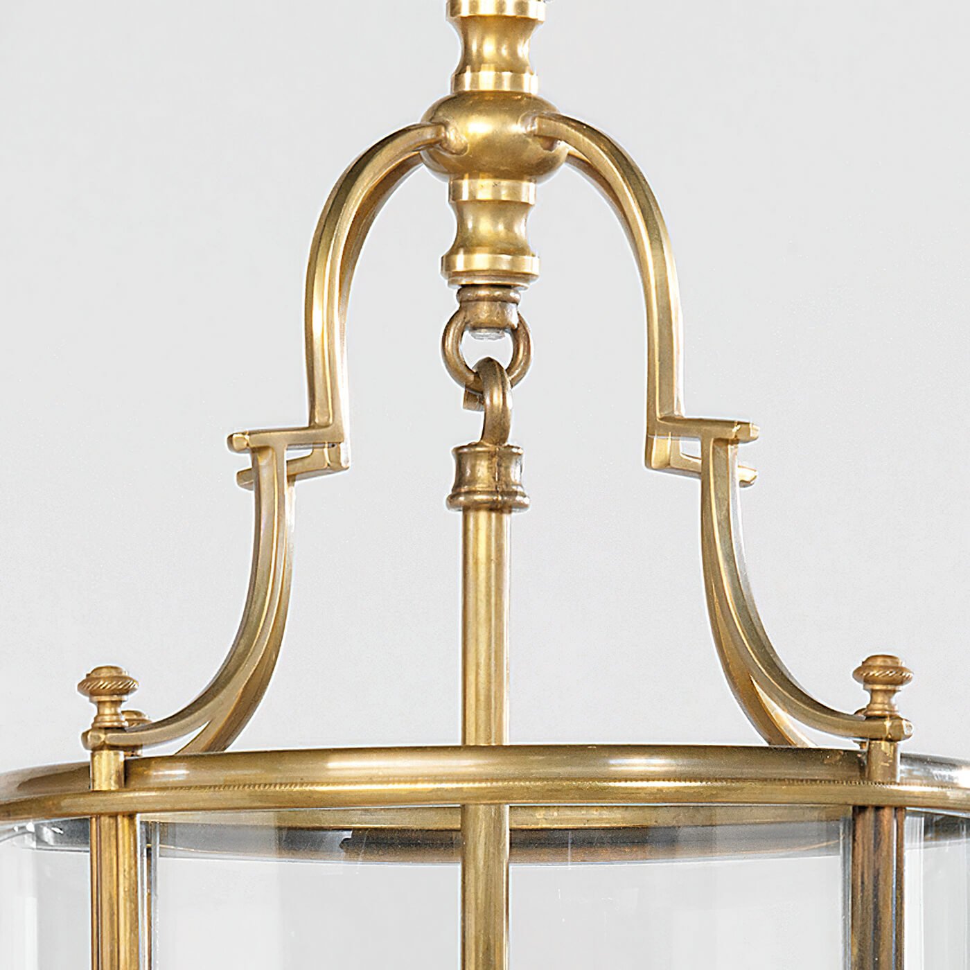 Close-up top of antique lantern, brass detailing visible.