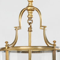 Close-up top of antique lantern, brass detailing visible.
