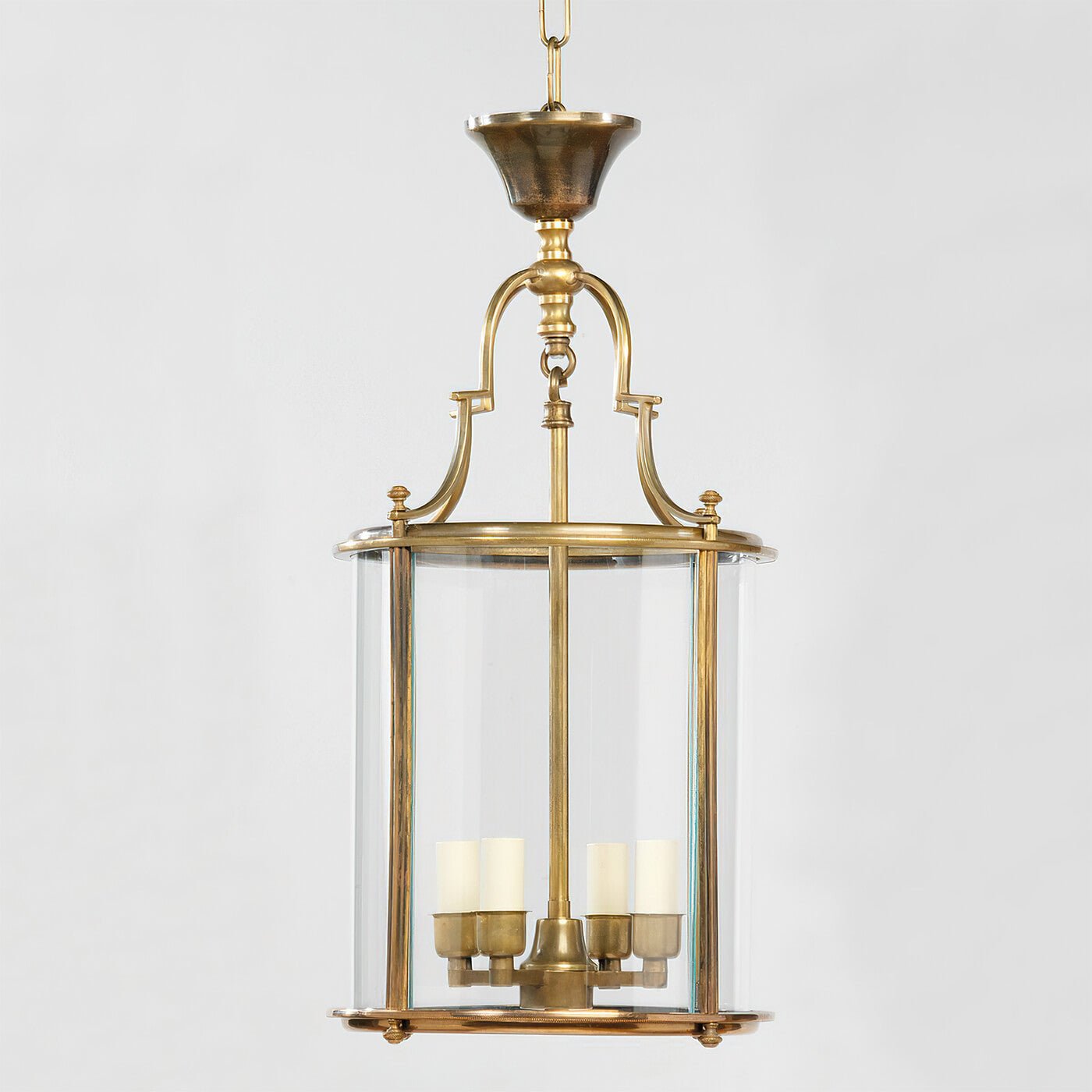 Antique round lantern, brass, glass panels, front angle.