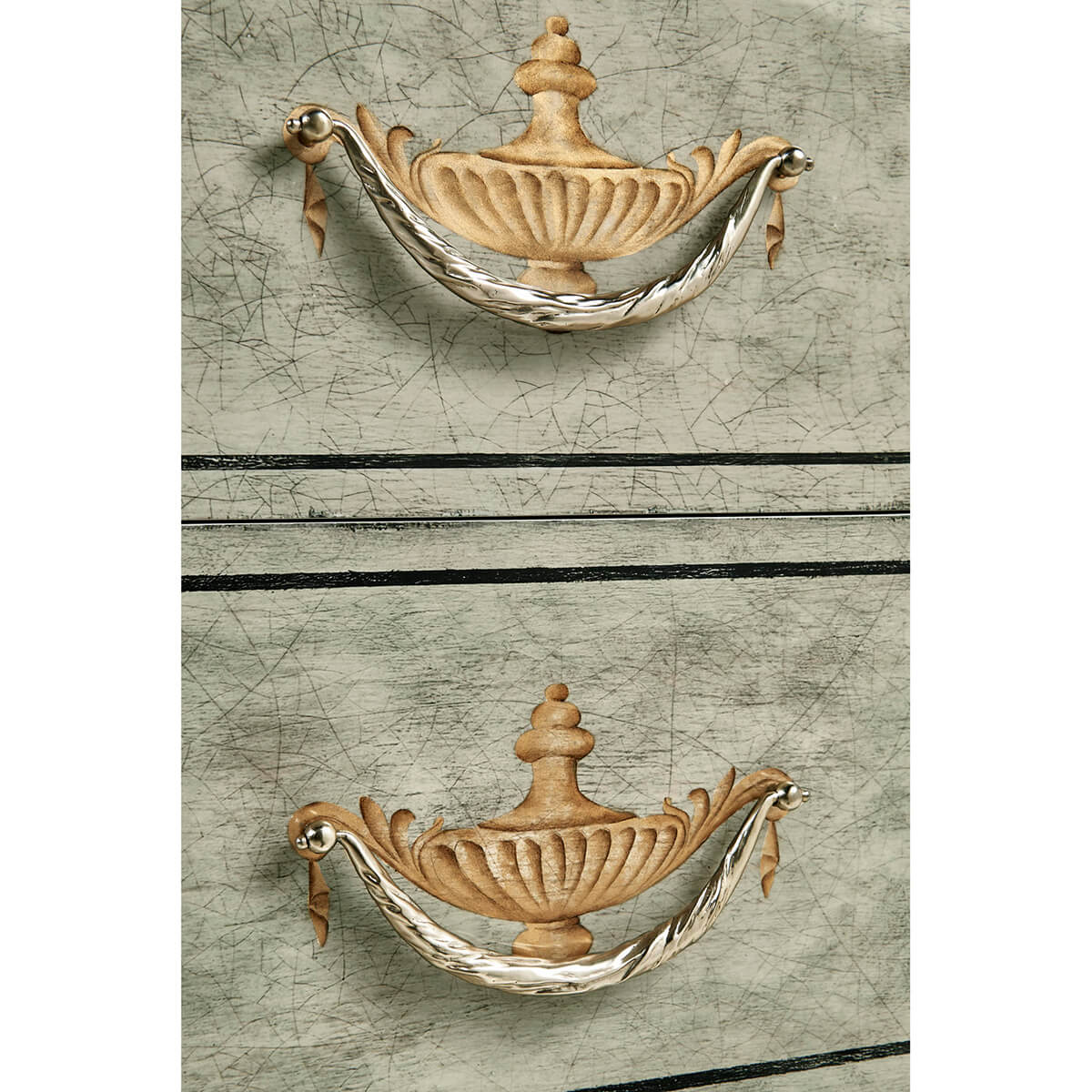 Detail of ornate handles, antique commode style.