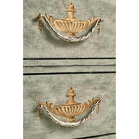 Detail of ornate handles, antique commode style.
