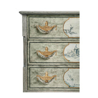 Close-up, drawer handles and painted details on commode.