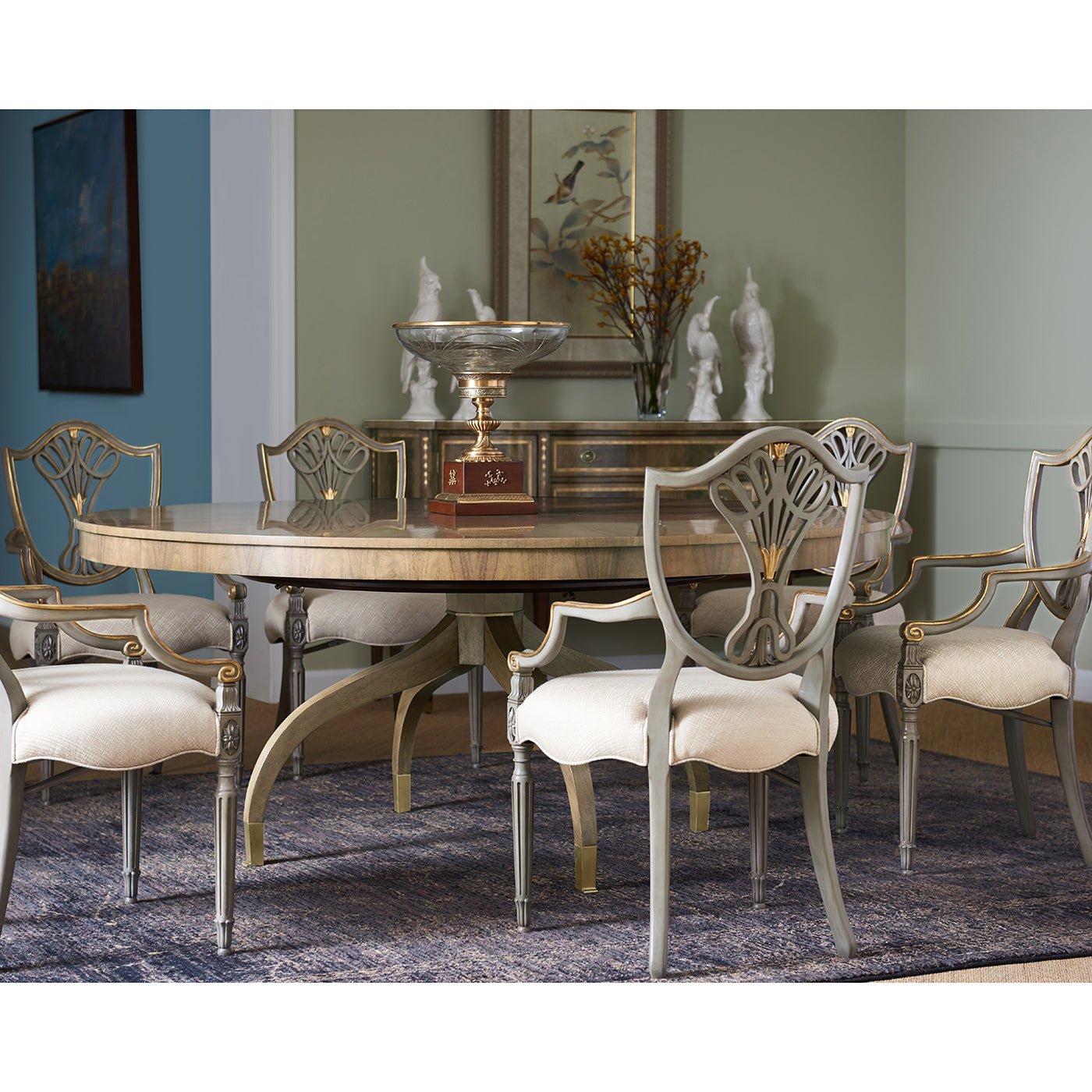 Dining chairs around table in elegantly decorated room.