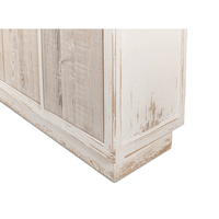 Base detail of rustic white sideboard close-up.