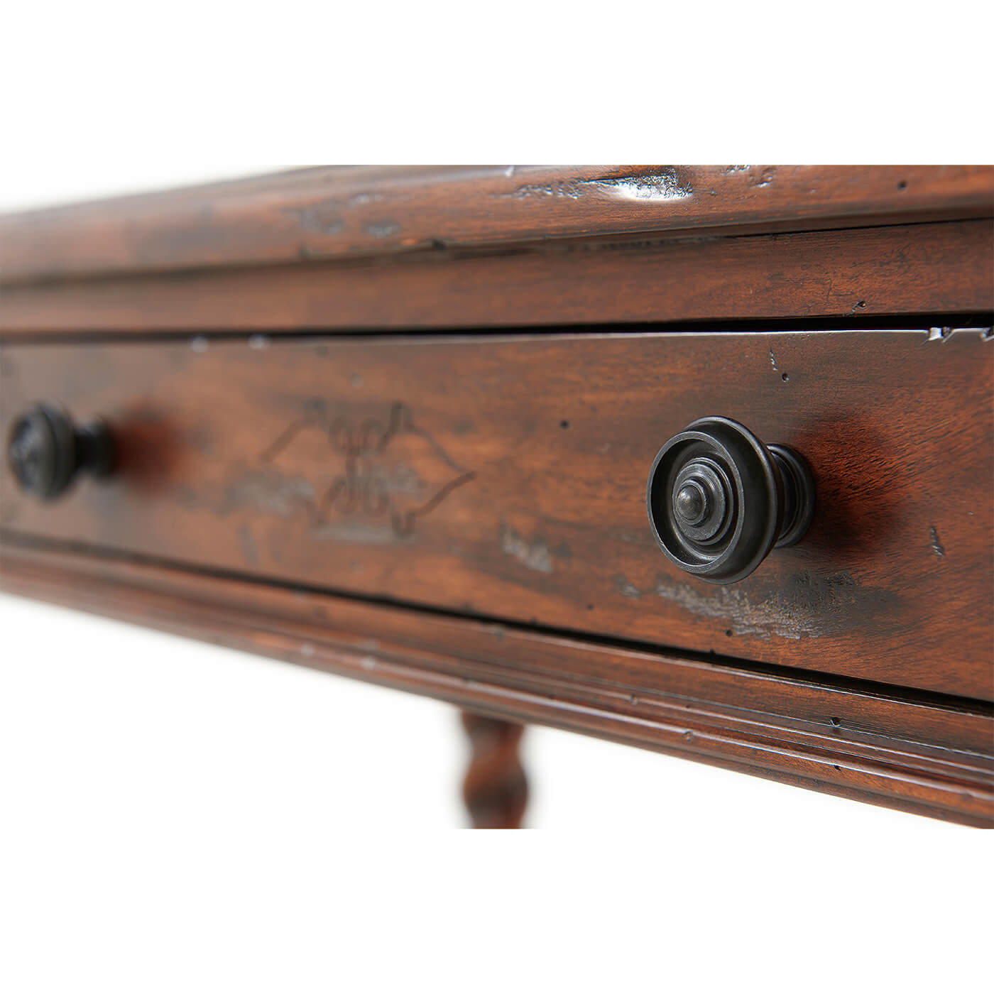 Detailed knob view on 17th-century style writing table drawer.
