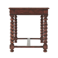 Side view of antique writing desk with ornate legs.