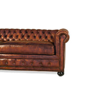 Right side close-up of Chesterfield leather sofa arm.