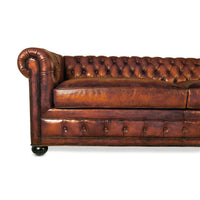 Left side close-up of Chesterfield leather sofa arm.