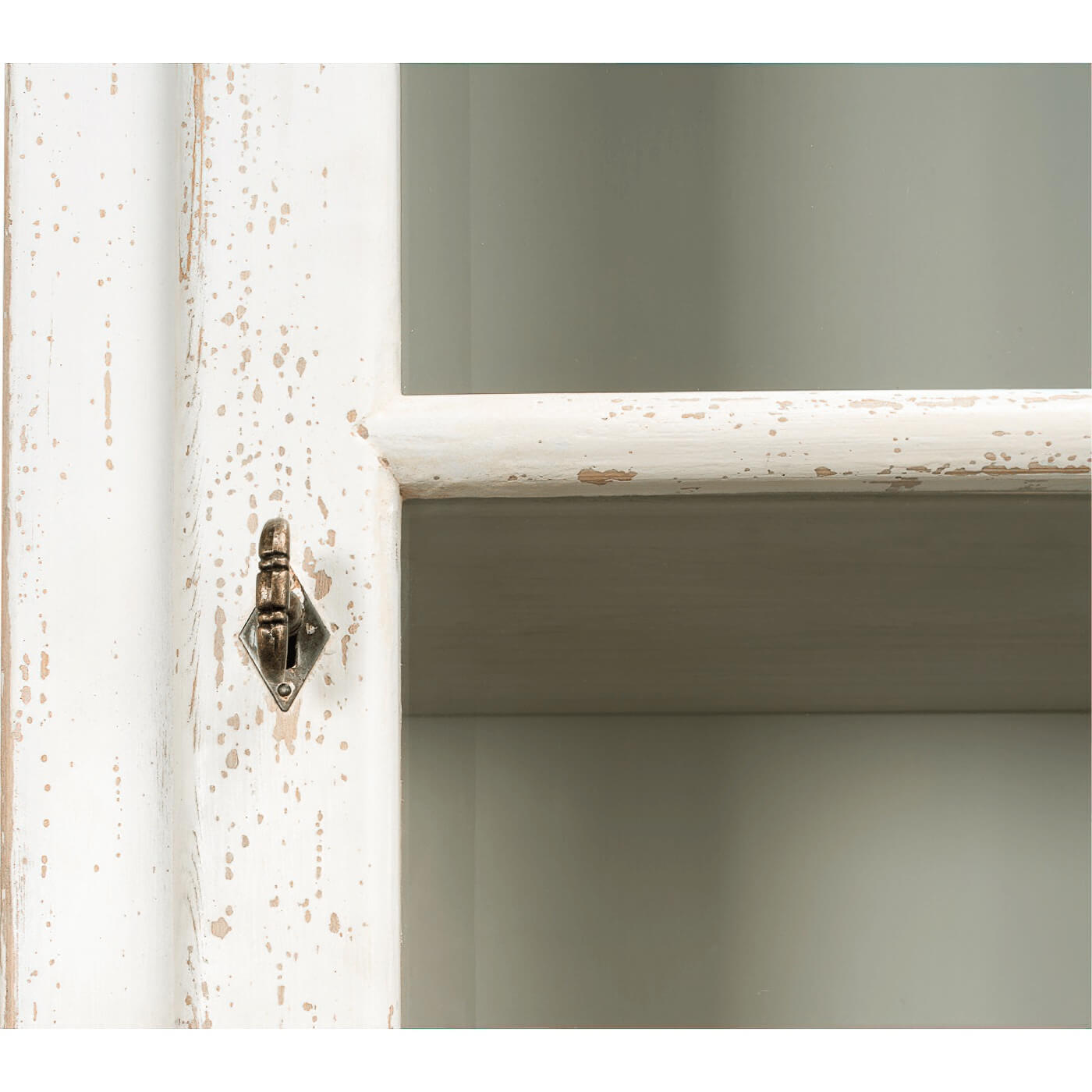 Latch detail on vintage-style rustic white bookcase.