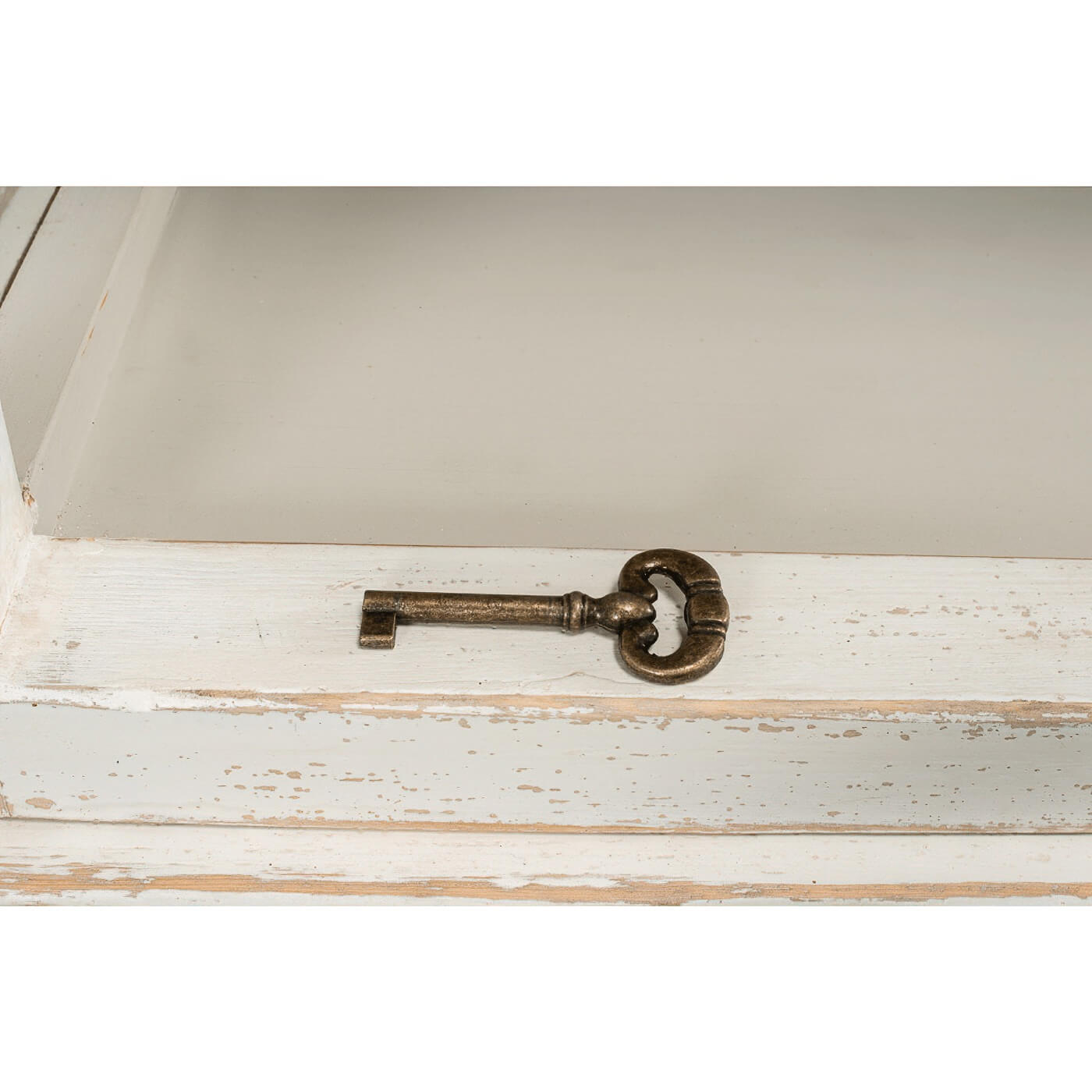 Rustic bookcase key detail on shelf, distressed white.