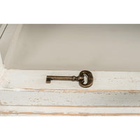 Rustic bookcase key detail on shelf, distressed white.