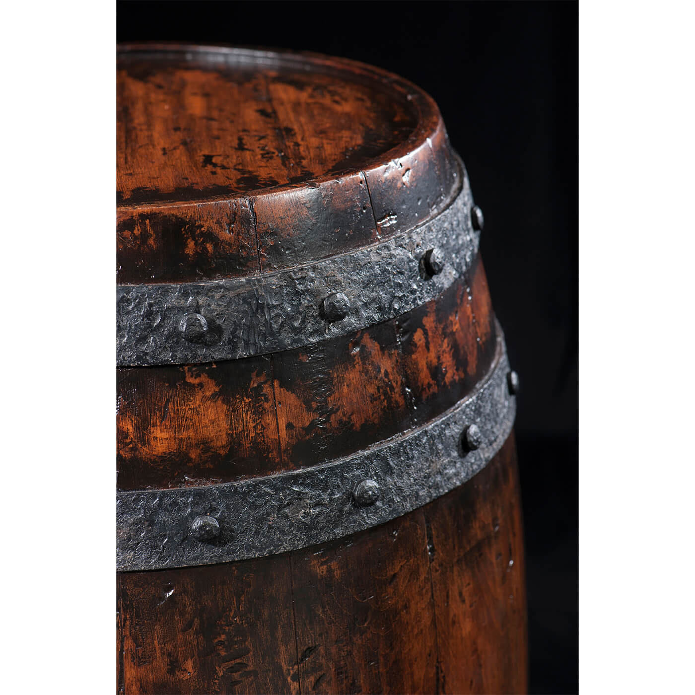 Close-up of wooden barrel accent table metal bands.