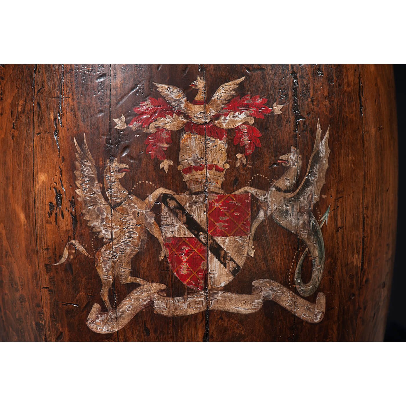 Detailed emblem on wooden barrel accent table surface.