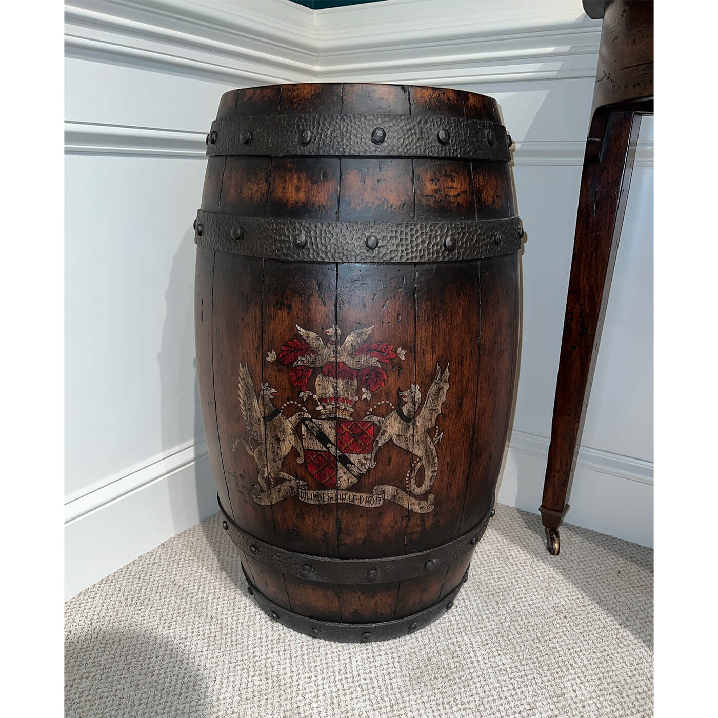 Wooden barrel accent table against white and teal walls.