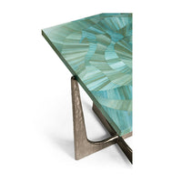 Corner detail of table showing green top and metal legs.