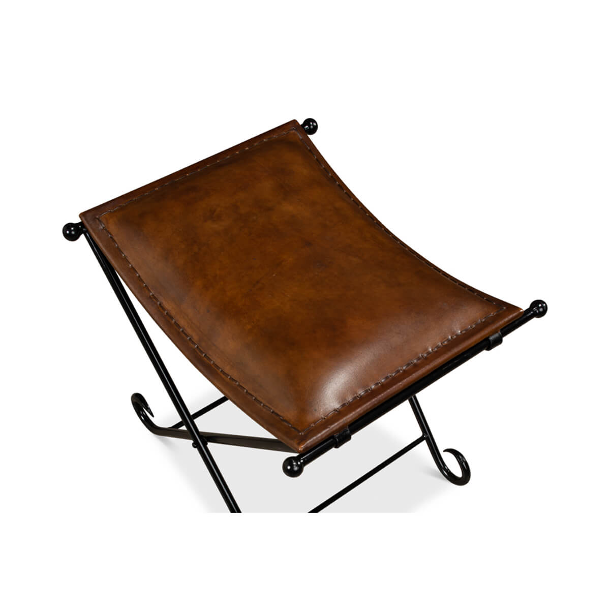 Close-up of brown leather seat on metal stool.
