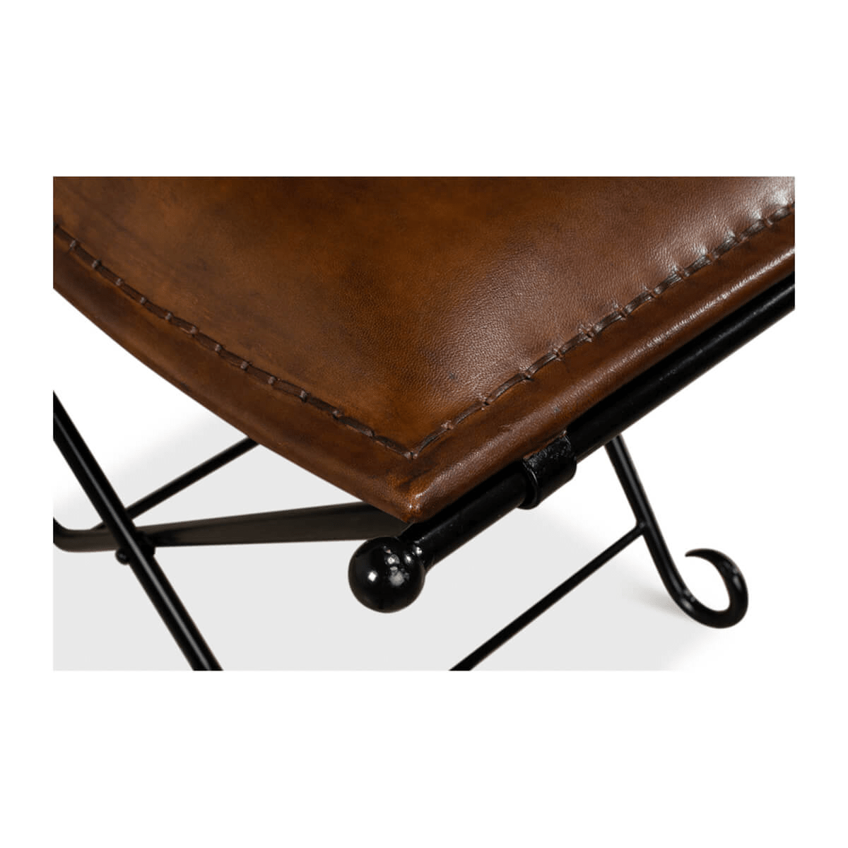 Close-up of leather stool detailing corner stitching.