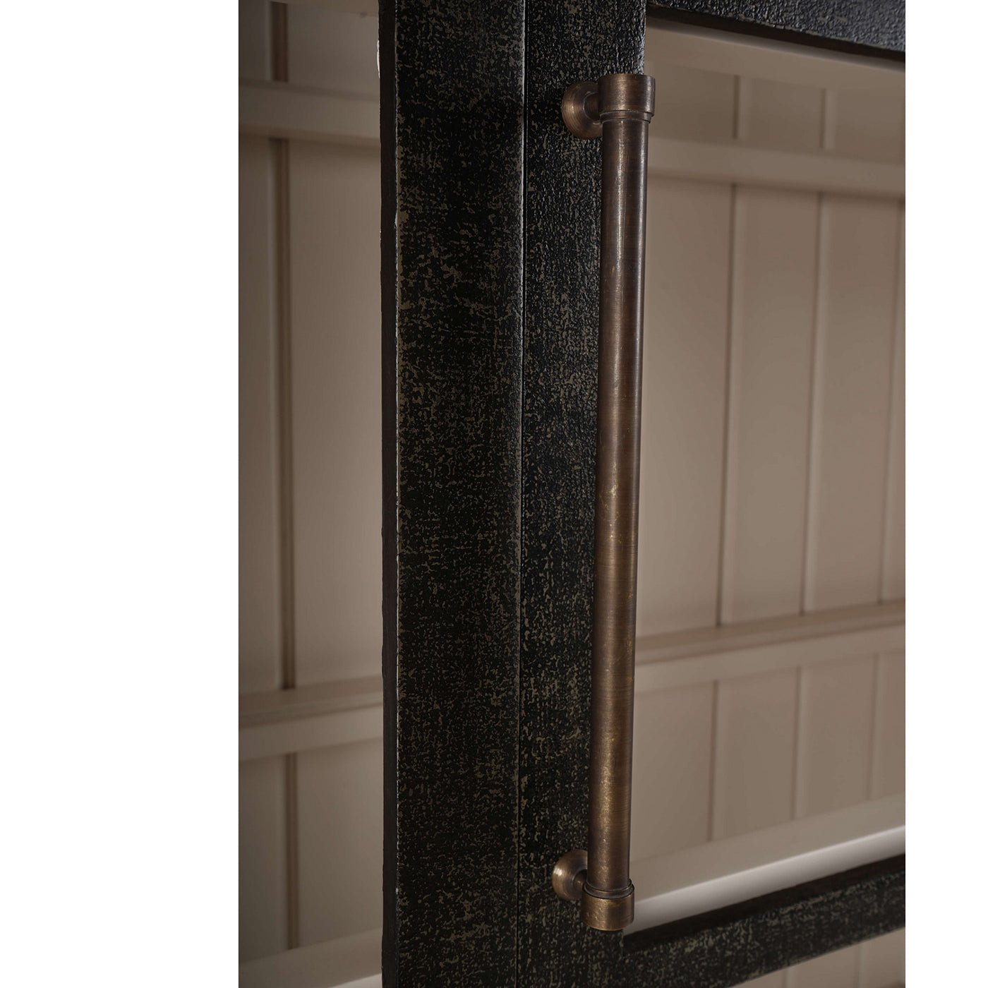 Close-up arched display cabinet handle, metal finish.