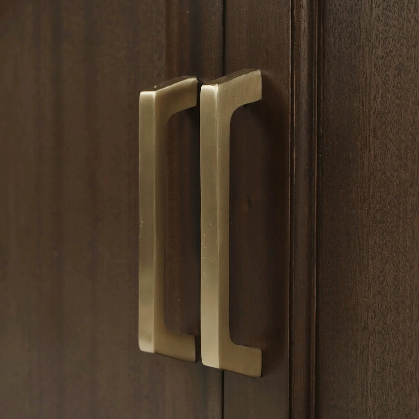Close-up of arched cabinet handle.