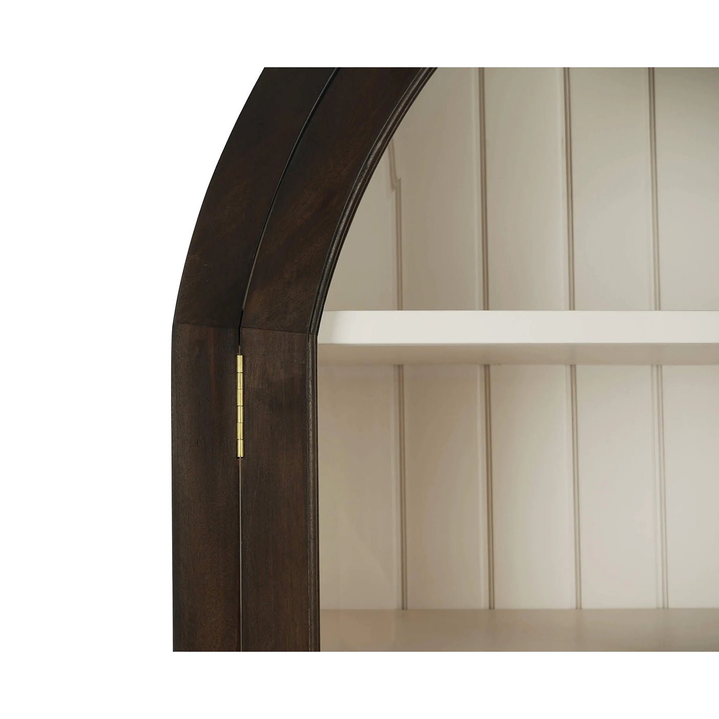 Close-up of arched cabinet shelf detail.