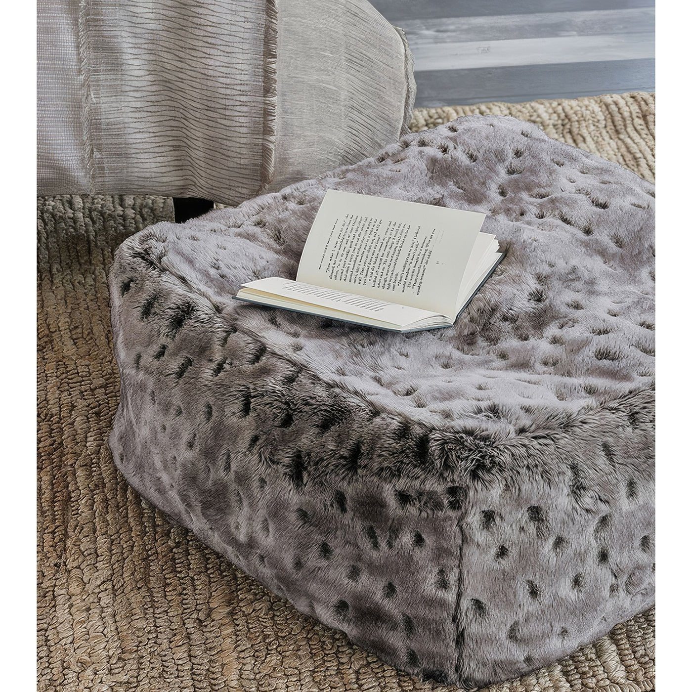 Pouf with open book, cozy living area.