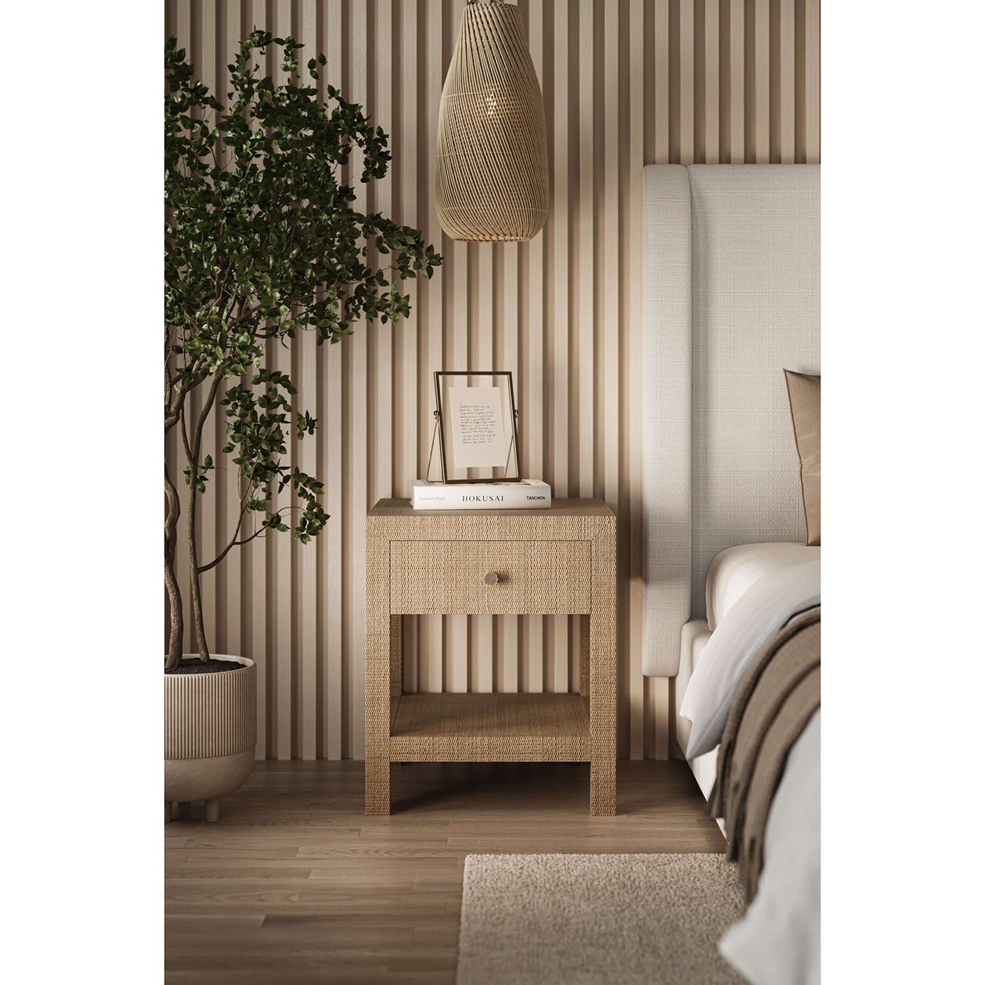 Nightstand next to Arctic white upholstered queen bed.