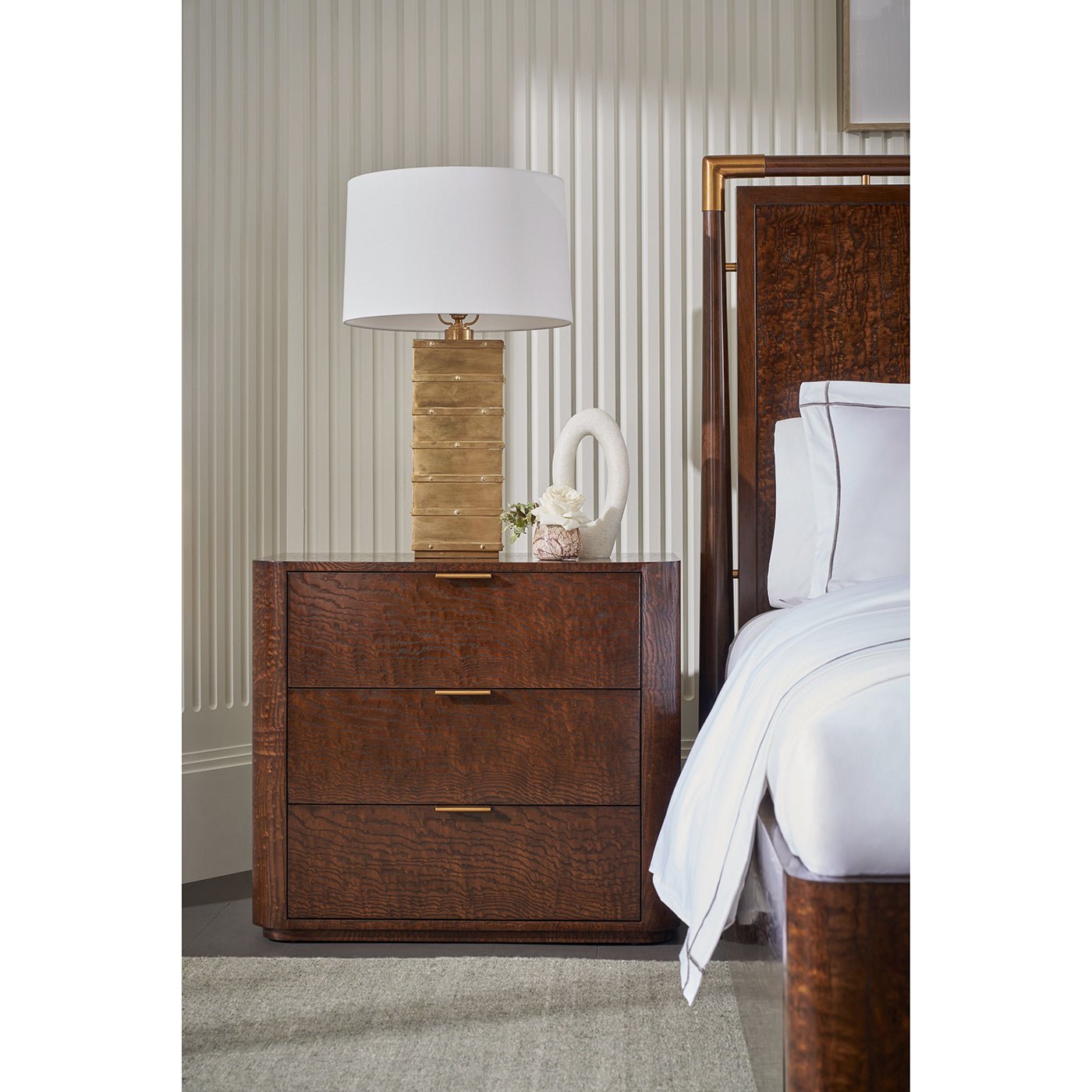 Art Deco nightstand detail with lamp and decor.