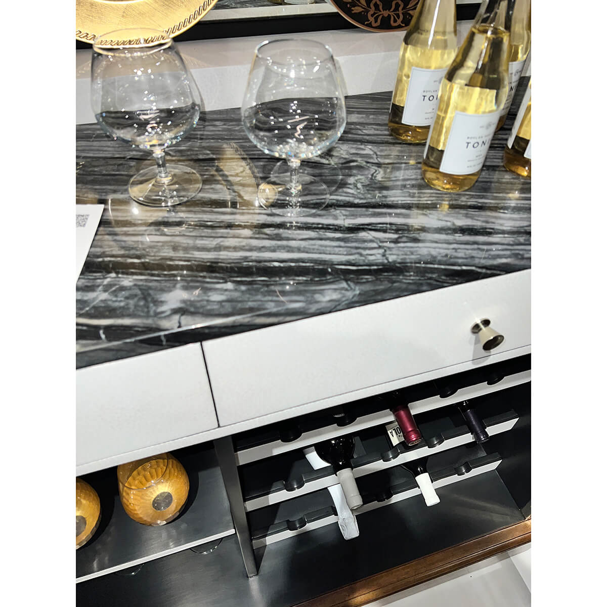 Art Deco bar cabinet with glassware on counter.
