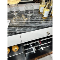 Art Deco bar cabinet with glassware on counter.
