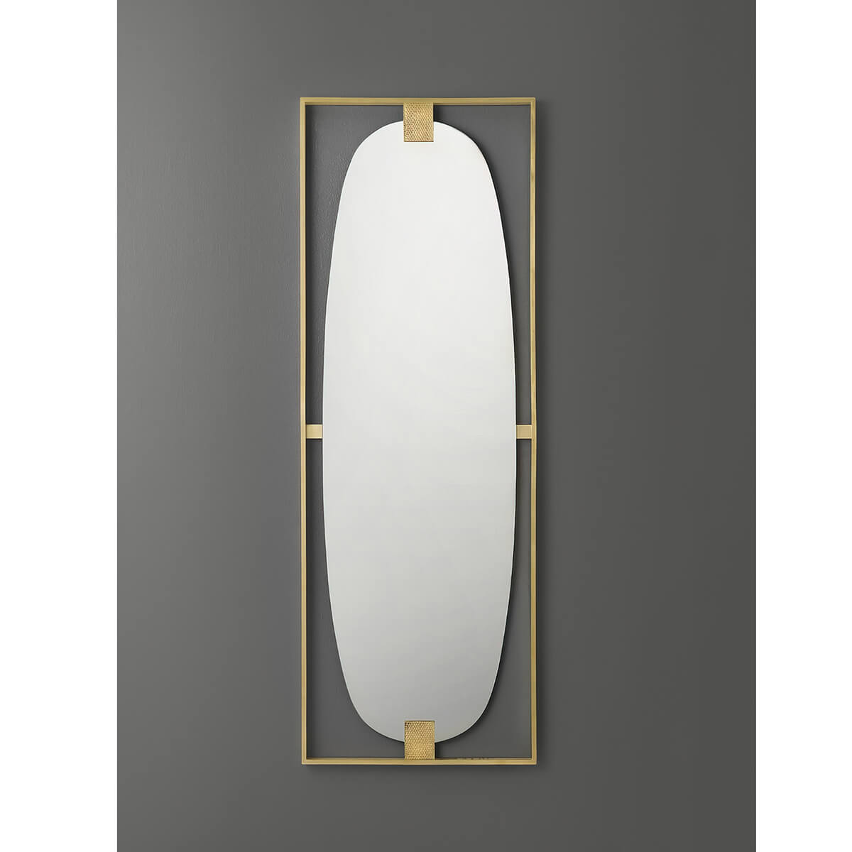 Full view of brass framed wall mirror against gray.