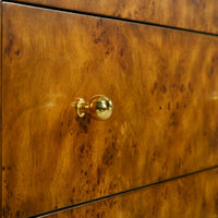 Drawer knob detail on Art Deco burl chest, gold hardware.