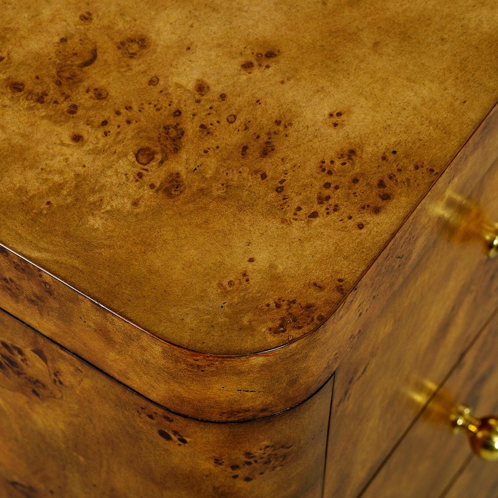 Close-up corner of Art Deco burl chest, rounded edge.