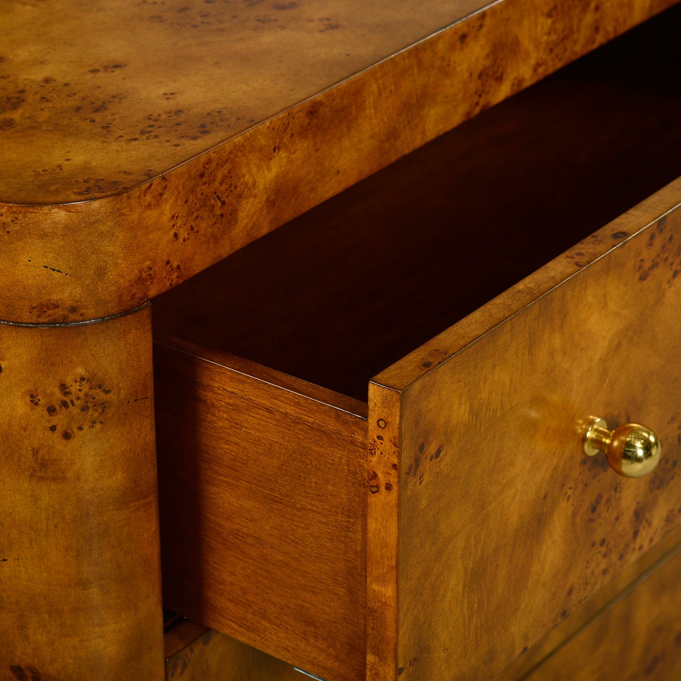 Open drawer of Art Deco burl chest, interior view.