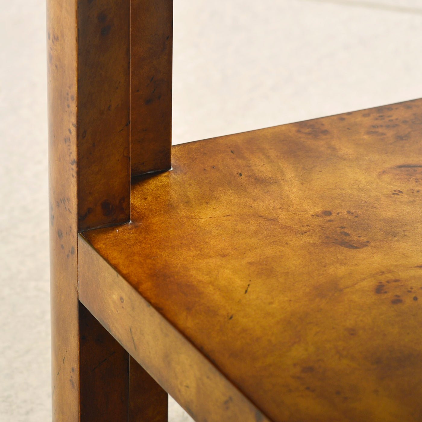 Detail of leg connecting to shelf on burl coffee table.