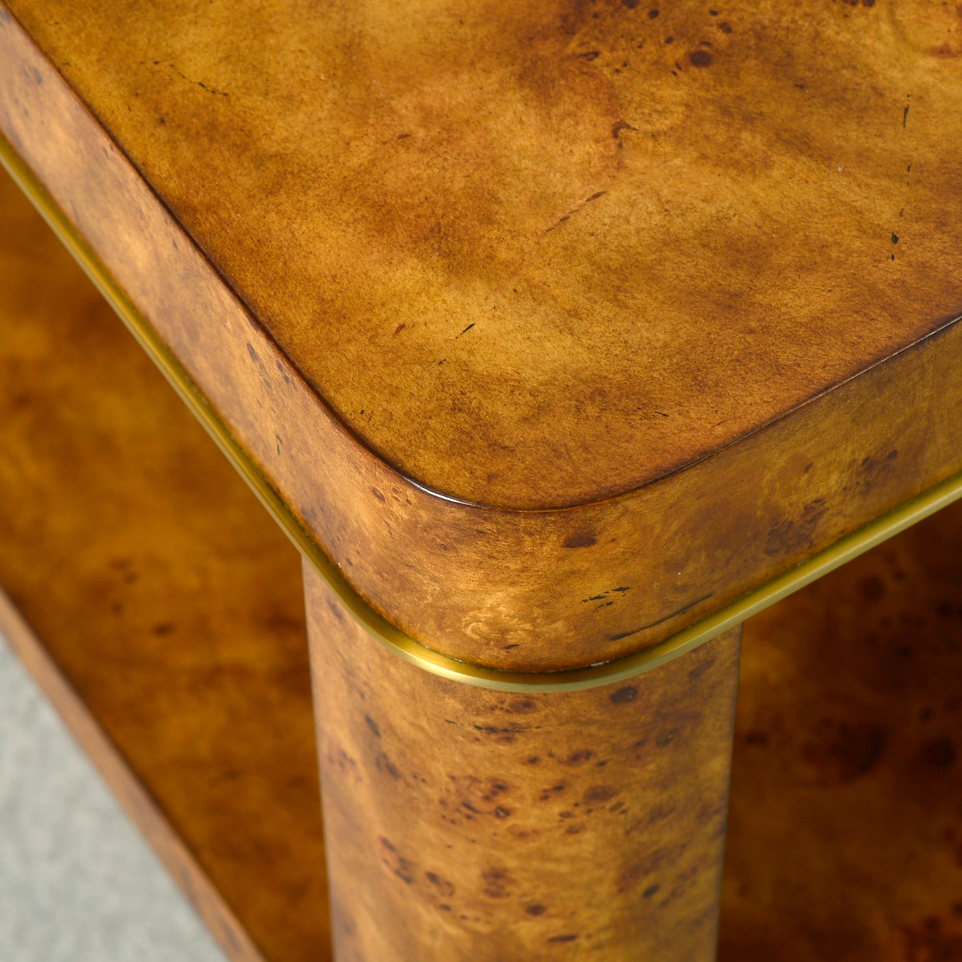 Corner edge view of Art Deco burl coffee table.