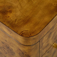 Corner detail of Art Deco burl dresser, rounded edges.
