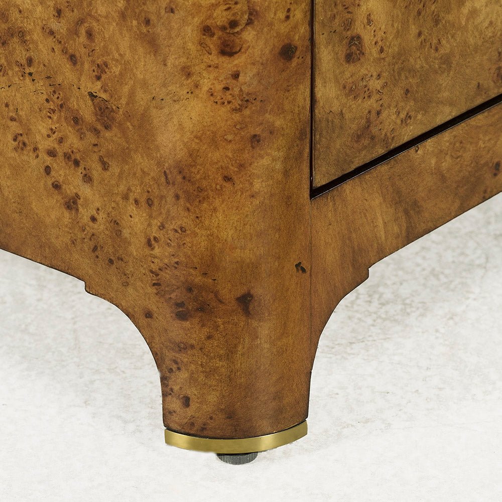 Burl nightstand leg detail with protective foot.