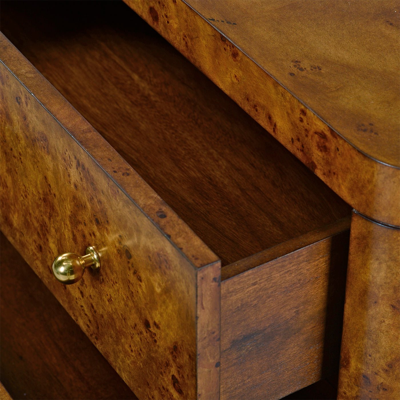 Open drawer showing interior wood of nightstand.