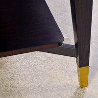 Leg design and shelf detail of walnut coffee table.